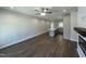 Spacious living room featuring hardwood floors, a ceiling fan, and an open layout with kitchen views at 202 S Pearl St, Princeton, NC 27569