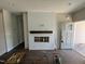 Bright living room featuring a decorative fireplace with a wood mantel and shiplap surround at 202 S Pearl St, Princeton, NC 27569
