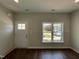 Bright living room with hardwood floors, a large window, and a freshly painted walls at 202 S Pearl St, Princeton, NC 27569