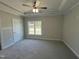 Relaxing main bedroom with tray ceiling, ceiling fan, neutral carpet, and plenty of natural light at 202 S Pearl St, Princeton, NC 27569