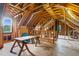 Unfinished attic space with exposed wooden beams and natural light; perfect for custom renovation at 209 Bradley Dr, Benson, NC 27504
