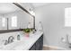 Modern bathroom featuring a double sink vanity with granite countertop and a decorative mirror at 209 Bradley Dr, Benson, NC 27504