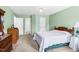 Spacious bedroom has light green walls, carpet, and two closets with white doors at 209 Bradley Dr, Benson, NC 27504