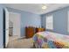 Comfortable bedroom features a ceiling fan, dresser, and a colorful bedspread on a wooden frame at 209 Bradley Dr, Benson, NC 27504