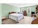Cozy bedroom with light green walls, carpet, a ceiling fan, and two windows for natural light at 209 Bradley Dr, Benson, NC 27504