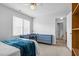 Well-lit bedroom features a ceiling fan and blue furnishings in a room with neutral colored carpet at 209 Bradley Dr, Benson, NC 27504