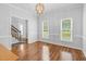 An empty dining room with wood floors, neutral walls, and a chandelier at 209 Bradley Dr, Benson, NC 27504