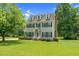 Charming two-story home with blue shutters and a well-manicured lawn at 209 Bradley Dr, Benson, NC 27504