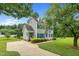 A charming home featuring a long driveway and lush, green landscaping at 209 Bradley Dr, Benson, NC 27504