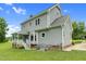 Rear exterior view with a covered back porch, deck and spacious backyard at 209 Bradley Dr, Benson, NC 27504