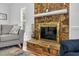 Close-up of stone fireplace, complete with tools and a hearth at 209 Bradley Dr, Benson, NC 27504