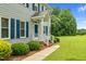 Inviting front porch with white railings and a well-maintained garden at 209 Bradley Dr, Benson, NC 27504