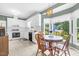 Well-lit eat-in kitchen has bright white cabinets, appliances, and beautiful backyard views at 209 Bradley Dr, Benson, NC 27504