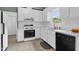Modern kitchen with white cabinets, stainless steel appliances and tiled backsplash at 209 Bradley Dr, Benson, NC 27504