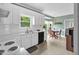 Bright kitchen with white cabinets, stainless steel sink, and breakfast nook area with dining table at 209 Bradley Dr, Benson, NC 27504