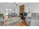 Comfortable living room with a stone fireplace and hardwood floors at 209 Bradley Dr, Benson, NC 27504