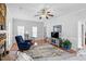 Bright living room features large windows and a stone fireplace at 209 Bradley Dr, Benson, NC 27504