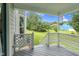 Relaxing covered porch with views of the expansive backyard and beautiful landscaping at 209 Bradley Dr, Benson, NC 27504