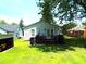 A well-manicured backyard featuring a small deck, offering a cozy outdoor space for relaxation and entertainment at 220 Howard St, Burlington, NC 27217
