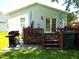Backyard deck with outdoor seating, grill, and a well-maintained lawn at 220 Howard St, Burlington, NC 27217