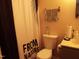 Cozy bathroom with a standard toilet, sink, and shower with nature-themed curtain at 220 Howard St, Burlington, NC 27217