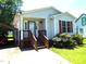 Charming single-story home with light siding, quaint front porch, and well-maintained landscaping at 220 Howard St, Burlington, NC 27217