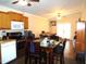 Open concept kitchen with wood cabinets, modern appliances, and a dining area at 220 Howard St, Burlington, NC 27217