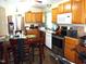 Traditional kitchen with stainless steel appliances, wooden cabinets, and dining table at 220 Howard St, Burlington, NC 27217