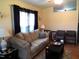Comfortable living room with a plush sofa, neutral walls, and a well-lit window at 220 Howard St, Burlington, NC 27217