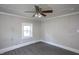 A bright bedroom features neutral walls and flooring with a ceiling fan and light fixture at 306 W Main St, Pine Level, NC 27568