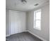 Bedroom featuring updated flooring, a window for natural light, and a closet at 306 W Main St, Pine Level, NC 27568