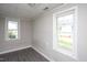 Well-lit bedroom featuring two windows offering views of the property's yard at 306 W Main St, Pine Level, NC 27568