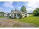 Charming one-story home with a covered front porch and a lush green yard at 306 W Main St, Pine Level, NC 27568
