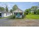 Charming cottage home featuring a quaint front porch and colorful landscaping at 306 W Main St, Pine Level, NC 27568