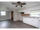 Bright kitchen features white cabinets, modern sink, and wood-look floors in an open layout at 306 W Main St, Pine Level, NC 27568