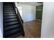 Inviting entryway featuring staircase and newly installed hardwood floors at 328 Mccarthy Dr, Clayton, NC 27527