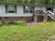 Single story home with brick foundation, light siding, blue shutters, and a small porch nestled in a wooded area at 3539 Charlies Ct, Wake Forest, NC 27587