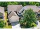 Aerial view of a well-maintained home featuring a manicured lawn, mature trees, and inviting driveway at 3661 Manifest Pl, Cary, NC 27519