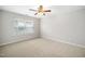 Bedroom with neutral walls and carpeting, large window, and a ceiling fan at 3661 Manifest Pl, Cary, NC 27519