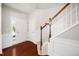 Open foyer with hardwood floors, staircase, and wainscoting at 3661 Manifest Pl, Cary, NC 27519