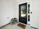 Inviting front entry with a black-framed glass door, 'hello' doormat, and flowers at 3661 Manifest Pl, Cary, NC 27519