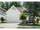 Charming two-story home with a well-manicured lawn, large shade tree, and attached garage at 3661 Manifest Pl, Cary, NC 27519