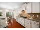 Bright kitchen featuring white cabinets, granite countertops, stainless appliances, and a cozy breakfast nook at 3661 Manifest Pl, Cary, NC 27519