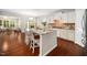Bright kitchen island featuring granite countertops, white cabinets, and stainless steel appliances at 3661 Manifest Pl, Cary, NC 27519