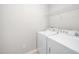 Well-lit laundry area equipped with a modern washer, dryer, and shelving at 3661 Manifest Pl, Cary, NC 27519