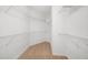 Spacious walk-in closet with extensive shelving, and neutral carpeting at 3661 Manifest Pl, Cary, NC 27519