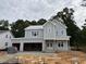 New construction home featuring light gray siding, white trim, and an attached two car garage at 3825 Fairway View Dr, Fuquay Varina, NC 27526