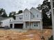 New construction home featuring light gray siding, white trim, and an attached two car garage at 3825 Fairway View Dr, Fuquay Varina, NC 27526