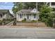 A charming house with a classic front porch, featuring mature landscaping and a welcoming entrance, embodying timeless appeal at 407 N Boylan Ave, Raleigh, NC 27603