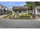 A charming house with a classic front porch, featuring mature landscaping and a welcoming entrance, embodying timeless appeal at 407 N Boylan Ave, Raleigh, NC 27603